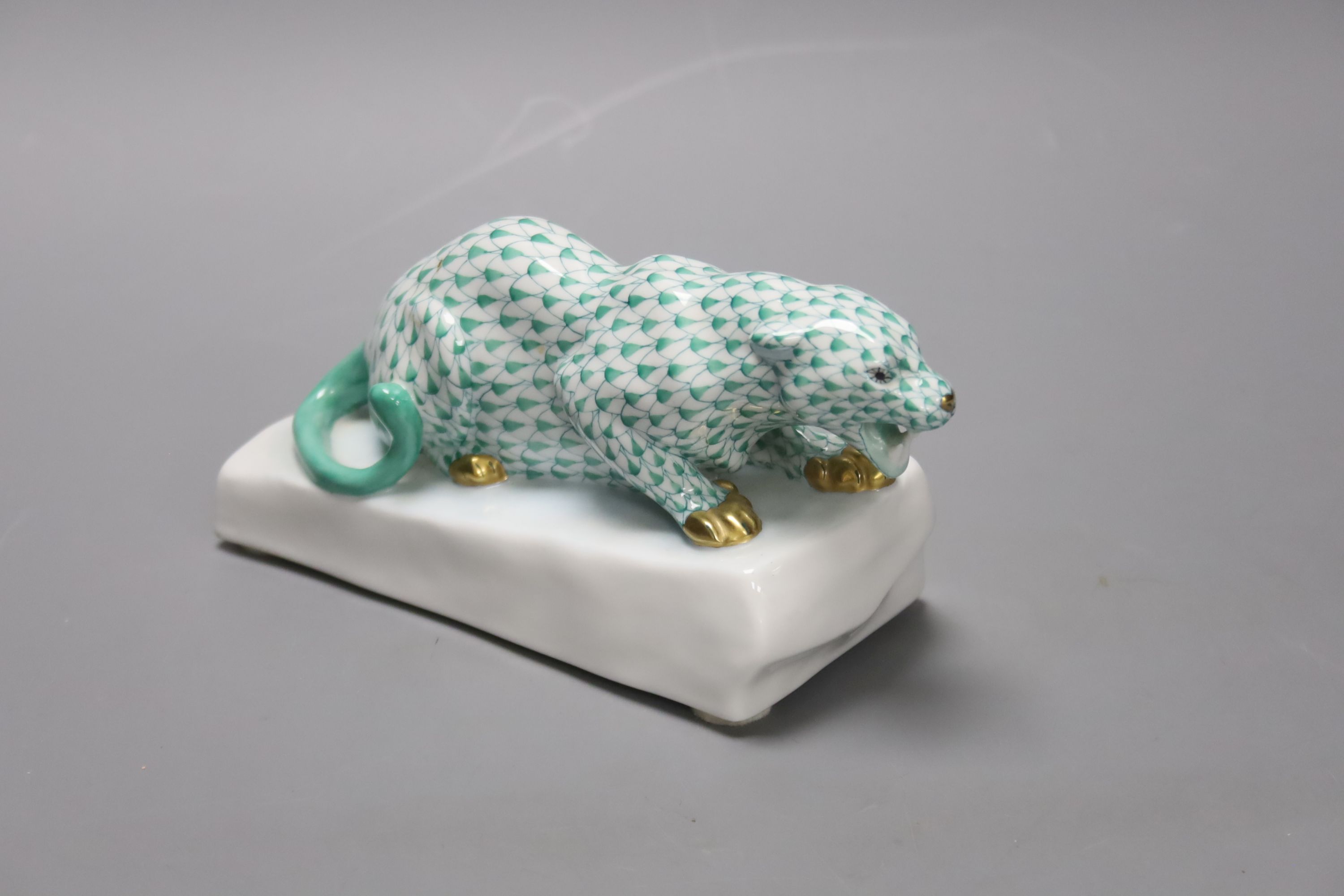 A Herend green ’fishnet’ model of a leopard crouching on a rock, signed Markup B